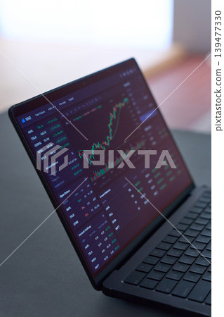 A laptop displaying stock charts A laptop displaying stock charts 139477330