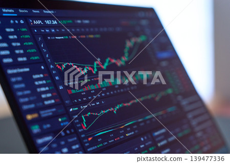 A laptop displaying stock charts A laptop displaying stock charts 139477336