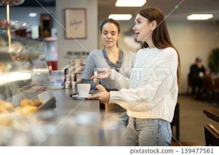 Two female friends met in a cafe 139477561