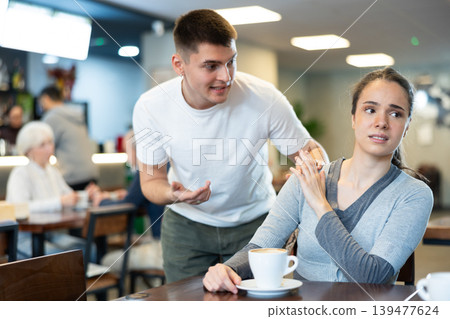 Girl rejects guy. Young man violates personal boundaries of girl Girl rejects guy. Young man violates personal boundaries of girl 139477624