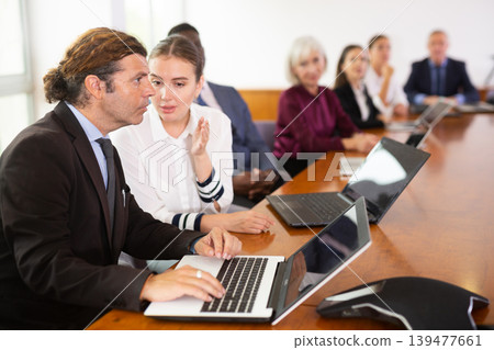 Female secretary chatting with her boss during conference Female secretary chatting with her boss during conference 139477661