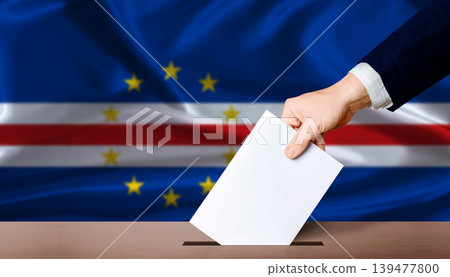 Cape Verde Parliamentary vote 2026. Hand placing a ballot in ballot box with the Cape Verdean flag in the background 139477800