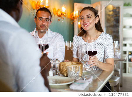Couple and their friend in the restaurant Couple and their friend in the restaurant 139477881