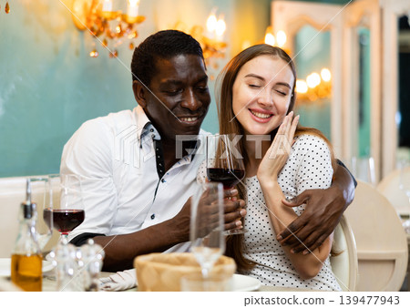 Adult couple on romantic date drinking red wine at restaurant Adult couple on romantic date drinking red wine at restaurant 139477943