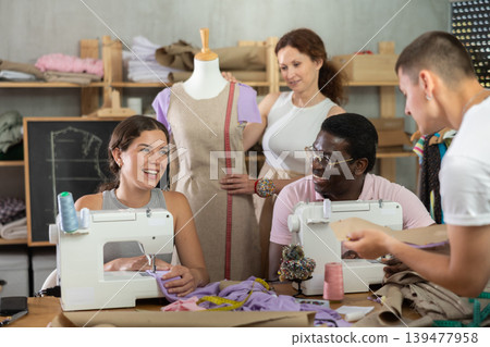 Group of happy attendees of dressmaking courses engaged in different activities Group of happy attendees of dressmaking courses engaged in different activities 139477958