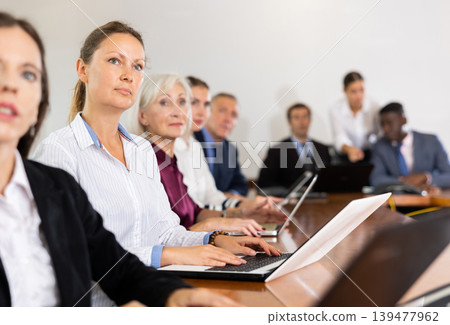 Portrait of business woman using laptop at business meeting Portrait of business woman using laptop at business meeting 139477962