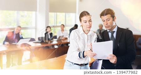 Senior manager checking documents from female manager in a meeting room 139477982