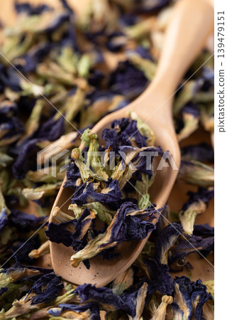 Dried butterfly pea flowers in a wooden spoon Dried butterfly pea flowers in a wooden spoon 139479151