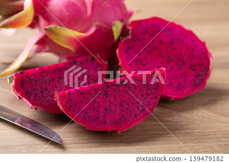 Fresh red dragon fruit on wooden background, Tropical fruit in summer season Fresh red dragon fruit on wooden background, Tropical fruit in summer season 139479182