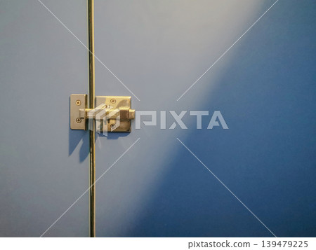 Close-Up of Blue Restroom Stall Door Lock and Latch Close-Up of Blue Restroom Stall Door Lock and Latch 139479225