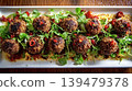 Sesame coated meatballs with chili and fresh greens 139479378