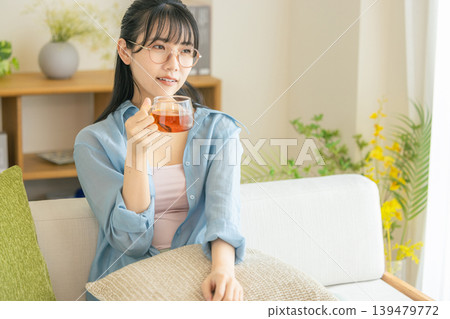 Woman drinking tea in the living room 139479772