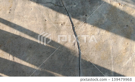 Cracked Concrete Floor with Shadow Pattern Background 139479968
