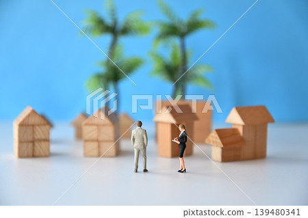 Image of a saleswoman explaining the features of a house. Image of a saleswoman explaining the features of a house. 139480341