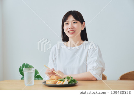 Young women chatting while eating breakfast Young women chatting while eating breakfast 139480538