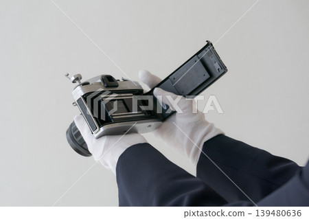 A person who appraises used cameras A person who appraises used cameras 139480636