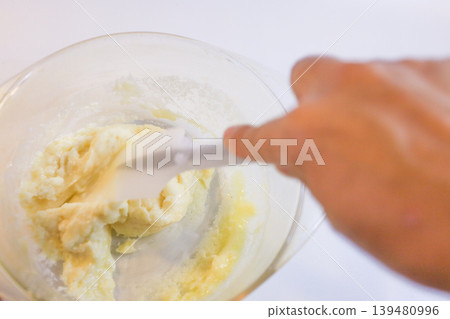 Making choux pastry by mixing melted butter and flour. Making choux pastry by mixing melted butter and flour. 139480996