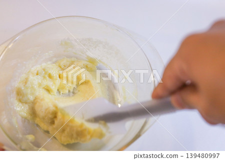 Making choux pastry by mixing melted butter and flour. Making choux pastry by mixing melted butter and flour. 139480997