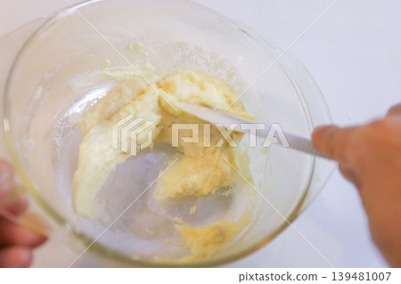 Making choux pastry by mixing melted butter and flour. 139481007