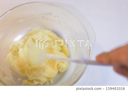 Making choux pastry by mixing melted butter and flour. Making choux pastry by mixing melted butter and flour. 139481016