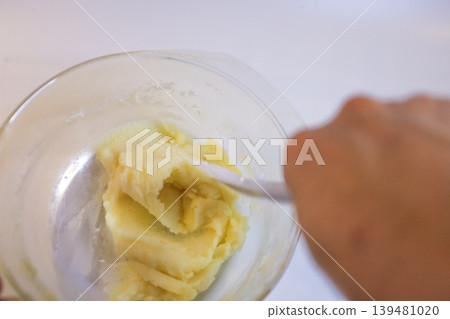 Making choux pastry by mixing melted butter and flour. Making choux pastry by mixing melted butter and flour. 139481020
