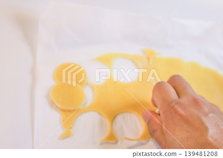 The process of cutting out shapes from cookie dough for choux pastry. The process of cutting out shapes from cookie dough for choux pastry. 139481208