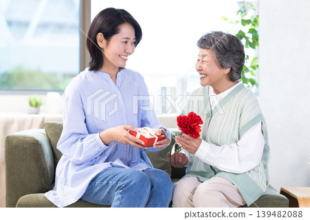 Mother's Day: Senior women receive carnations and gifts. 139482088