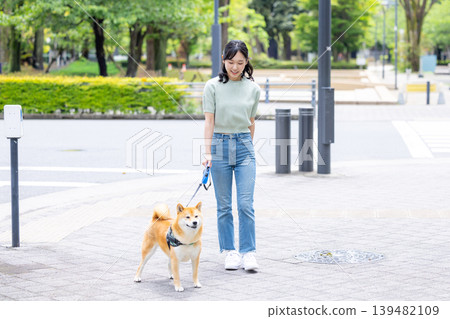 Lifestyle: A woman walking her dog 139482109