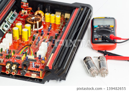 Multimeter with test probes resistors and a circuit board Multimeter with test probes resistors and a circuit board 139482655