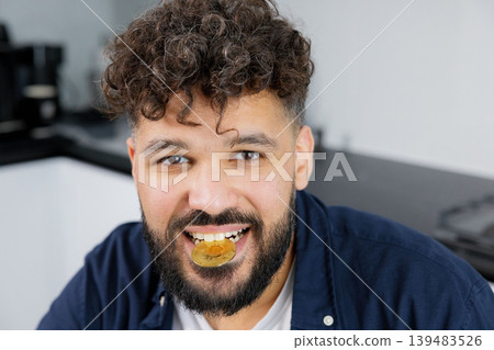 Man biting bitcoin coin showing investment concept 139483526