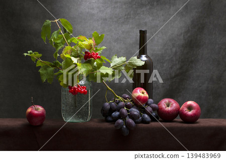 Still life with ripe grapes and red viburnum branches Still life with ripe grapes and red viburnum branches 139483969