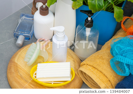 Assortment of Soaps and Dispensers bottles. Natural eco set of shower gels and lotions and a washcloth 139484007