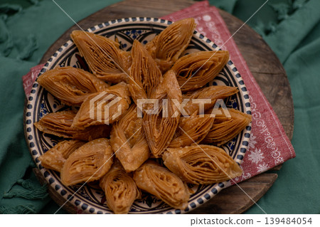 Crimean Tatar Baklava, a traditional pastry in bowl. Sweets diamond shapes food Crimean Tatar Baklava, a traditional pastry in bowl. Sweets diamond shapes food 139484054