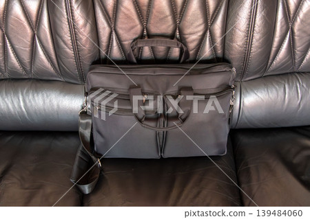 Black business laptop bag on leather car seat interior Black business laptop bag on leather car seat interior 139484060