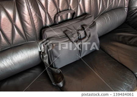 Black business laptop bag on leather car seat interior Black business laptop bag on leather car seat interior 139484061