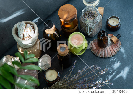 Scented candles and jars with essential oil. Dried lavender. Aromatherapy. Aroma lamp top view Scented candles and jars with essential oil. Dried lavender. Aromatherapy. Aroma lamp top view 139484091