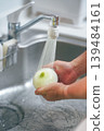 Hands of a person washing onions in the kitchen 139484161
