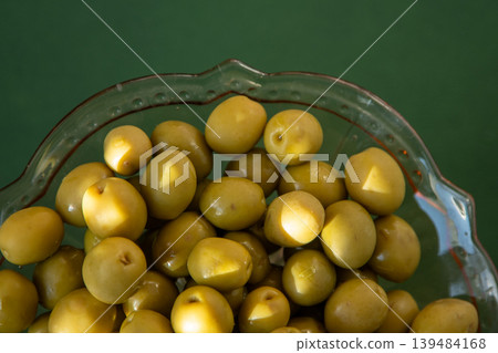 Green olives fruit close up top view, food background Green olives fruit close up top view, food background 139484168
