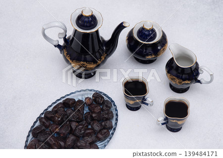 Coffee set with decanter creamer, blue sugar bowl and cups . Vintage tableware. Sweet dates fruit 139484171