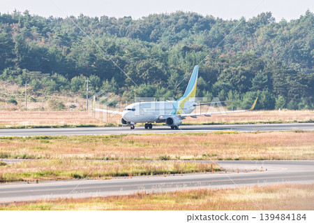 A passenger plane taxiing on the runway A passenger plane taxiing on the runway 139484184