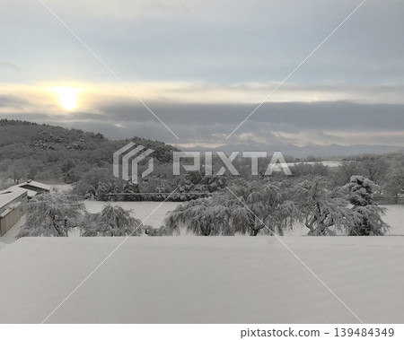 Winter sunrise over a snowy landscape Winter sunrise over a snowy landscape 139484349