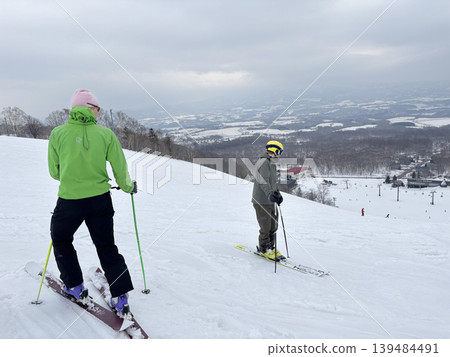 Niseko, Japan - April 3, 2025 : Snowboarders and skiers enjoy activities at Annupuri ski resort, Niseko, Hokkaido, Japan on April 3, 2025. 139484491