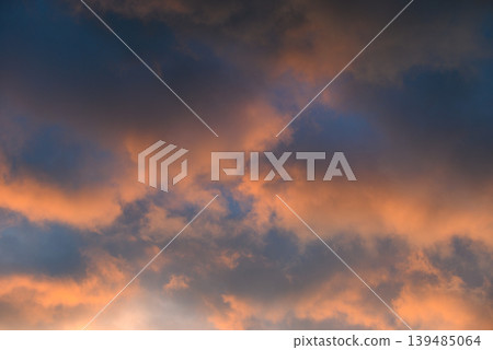 Dramatic pastel sunset clouds in blue evening sky Dramatic pastel sunset clouds in blue evening sky 139485064