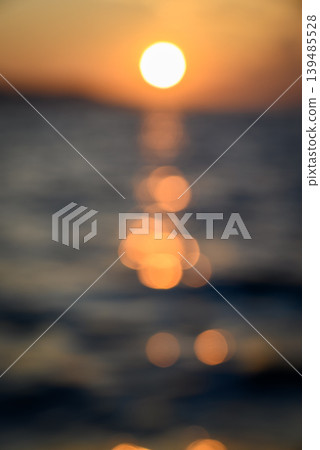 Abstract bokeh sunset over ocean with golden reflections Abstract bokeh sunset over ocean with golden reflections 139485528