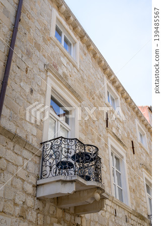 Historic stone facade with wrought-iron balcony Historic stone facade with wrought-iron balcony 139485567