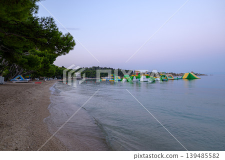 Tranquil pebble beach at dusk in Makarska riviera in Croatia Tranquil pebble beach at dusk in Makarska riviera in Croatia 139485582