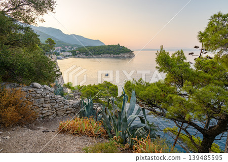 Serene coastal Makarska bay on Adriatic sea at sunrise in Makarska, Croatia Serene coastal Makarska bay on Adriatic sea at sunrise in Makarska, Croatia 139485595