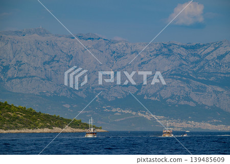 Tourist boats on Adriatic Sea with Biokovo Mountain Range Backdrop in Makarska riviera, Croatia 139485609