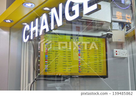 Currency exchange booth interior with electronic rate board showing multiple foreign currencies, in Hong Kong Currency exchange booth interior with electronic rate board showing multiple foreign currencies, in Hong Kong 139485862