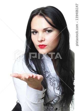 beautiful young woman blowing a kiss 139486147